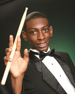 A picture of Darius Faison with drumsticks